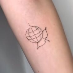 a small tattoo on the arm of a person with a globe and arrows around it