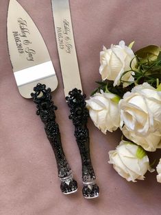 two knives and some flowers on a table