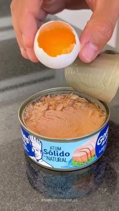 someone is dipping an egg into some kind of sauce in a can on the counter