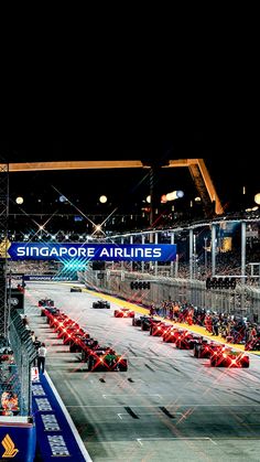 the race cars are lined up on the track for the night time lapse event