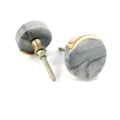 two marbled knobs with screws on white background