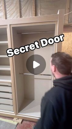 a man is opening the secret door in his closet to see what's inside