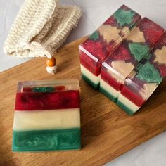 two soap bars sitting on top of a wooden cutting board