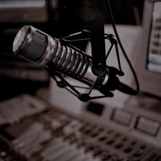 a microphone and sound board in a recording studio