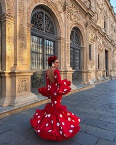 a woman in a red and white polka dot dress