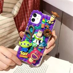 someone holding up their phone case with toy story characters on it