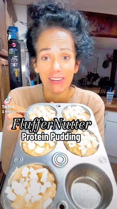 a woman holding a tray with some food on it and the words flufffer natter protein pudding in front of her face