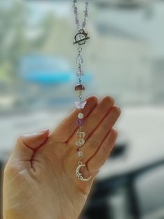 a person holding their hand in the air with a rosary hanging from it's side