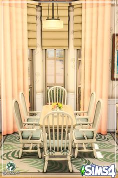 a table and chairs in a room with curtains