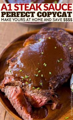 a wooden plate topped with meat covered in gravy