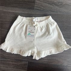 White Ruffle Hem Shorts - Never Worn Casual Cotton Bloomers With Ruffles, Cute White Bloomers With Elastic Waistband, Ruffled Bottoms For Summer Playtime, Cute Ruffled Bottoms For Playtime, White Bloomers With Elastic Waistband For Spring, Solid Cotton Bottoms With Ruffles, White Cotton Short Bloomers, Casual White Short Bloomers, Spring White Bloomers With Elastic Waistband