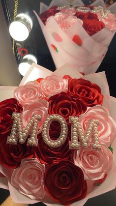 a bouquet of roses with the word mom written on it