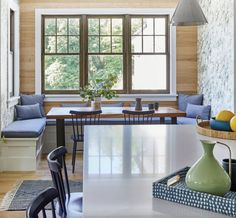 a dining room table with chairs and a bench