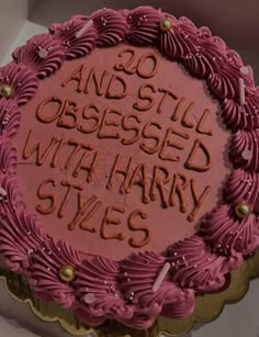 there is a pink cake with writing on it in the box that says 20 and still dressed with harry styles