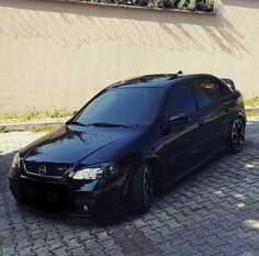 a black car is parked on the street