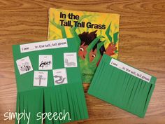 the book in the tall, tall grass is sitting on top of a wooden table