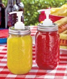 two red and yellow mason jars with soap dispensers on a picnic table