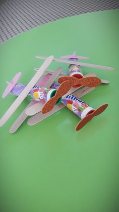 two toothbrushes are laying on top of a toy airplane that is shaped like an airplane