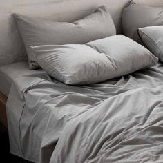 a bed with two pillows on top of it