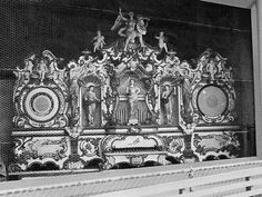 an ornately decorated fireplace with statues on it