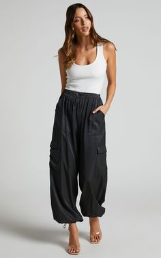 Hanabi - High Waisted Cargo Parachute Pant in Black | Showpo USA Urban Style Summer Cargo Pants With Elastic Waistband, Urban Style Summer Parachute Pants With Elastic Waistband, Black Utility Parachute Pants For Summer, Urban Parachute Pants With Elastic Waistband For Summer, Black Cargo Style Parachute Pants For Summer, High-waisted Parachute Pants With Elastic Waistband For Streetwear, Trendy High Waist Parachute Pants With Elastic Waistband, Trendy Nylon Cargo Pants For Streetwear, Black Summer Parachute Pants