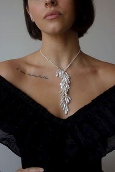 Inspired by swans, this statement piece features genuine freshwater pearls fashioned in  a way that mimics feathers.  There is no clasp, gently slide the pearl loop off to put on.  You can also adjust where it sits.  Closure: no clasp Materials: 14K Gold Filled or Sterling Silver Measures approx. 20" in length Handmade Elegant Feather Dangle Jewelry, Elegant Sterling Silver Feather Jewelry, Affordable Fine Jewelry, Shoulder Duster Earrings, Designer Necklace, Wrap Necklaces, Jewelry Pearl, Layered Jewelry, Necklace Choker