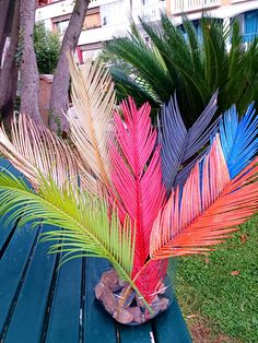 a colorful palm tree sitting on top of a blue bench