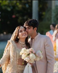 a bride and groom standing next to each other