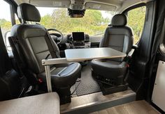 the interior of a van with two seats and a table