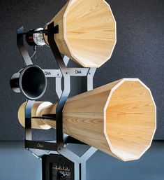 two large wooden objects sitting on top of a metal stand