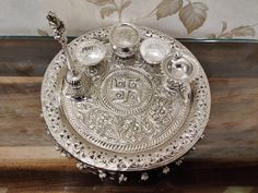 an ornate silver plate with candles on it