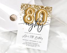 an 80th birthday party card with gold balloons and confetti on white paper