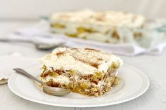 a piece of cake sitting on top of a white plate next to a silver spoon