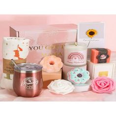 a pink box filled with lots of different types of items next to each other on top of a table