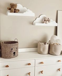 two teddy bears are sitting on top of the dressers in this nursery's room