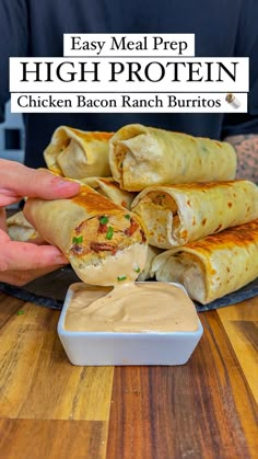 a person dipping sauce into a chicken bacon ranch burrito on a plate with the words, easy meal prep high protein chicken bacon ranch burritos