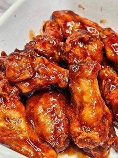 chicken wings with sauce in a white bowl