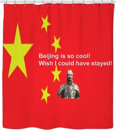 a red shower curtain with yellow stars and a statue in front of the chinese flag