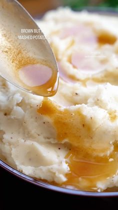 mashed potatoes with gravy being spooned