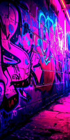 a wall covered in graffiti and purple light