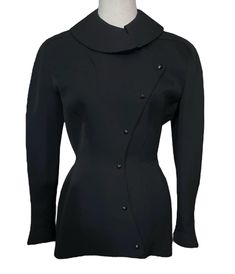 Thierry Mugler Black Dramatic Jacket. Rounded collar, single pocket on chest, military style snap closures dramatically curved, structured hourglass design. Extraordinary piece! Wearable Art. Extremely rare collector's piece. Marked Vintage Size 38 Made in France Shoulders: 18" Bust: 35" Waist: 28" Hips: 37" Length: 30" Hourglass Jacket, Mugler Black, Hourglass Design, Thierry Mugler, Military Style, Military Fashion, Wearable Art, Festival Season, Made In France