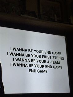 a man standing in front of a projection screen with the words i wanna be your end game