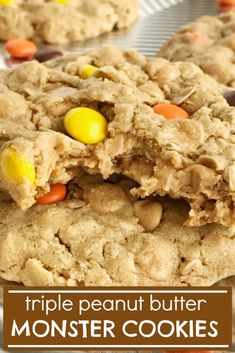 triple peanut butter monster cookies are stacked on top of each other with candy corn and m & ms in the middle