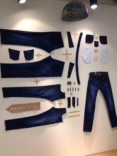 an assortment of clothing and accessories displayed on a wall