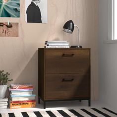 a bedroom with a dresser, lamp and pictures on the wall above it is shown