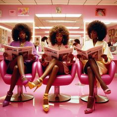 three women sitting on pink chairs reading magazines in a hairdressers shop, one is wearing high heeled sandals and the other has her legs crossed