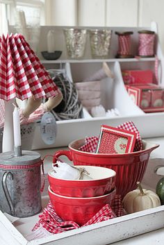 red and white dishes are sitting on a tray in the kitchen, ready to be used as centerpieces