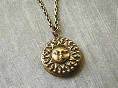 Small Sun Hidden Locket Necklace... This celestial sun locket has an antique brass finish and is attached to an antique brass round locket. The chain is a non tarnish soldered antique brass rolo chain made of brass. This chain closes with a lobster claw clasp. A great gift for women and men! Locket - 20mm Interior photo area - 14mm This beautiful celestial locket will be mailed to you gift wrapped. A great gift for someone you love! More celestial lockets listed in this section! https://www.etsy Bohemian Antique Gold Brass Locket Necklace, Bohemian Brass Locket Necklace With Vintage Charm, Antique Gold Medallion Locket Necklace In Bohemian Style, Bohemian Gold Brass Locket Necklace, Antique Gold Bohemian Medallion Locket Necklace, Bohemian Antique Gold Medallion Locket Necklace, Handmade Adjustable Antique Locket Necklace, Handmade Antique Adjustable Locket Necklace, Vintage Sun Design Jewelry Gift