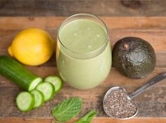 a smoothie with cucumbers, lemons and mint on a wooden table