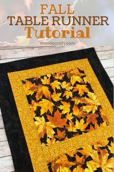 the fall table runner is made with black and yellow leaves